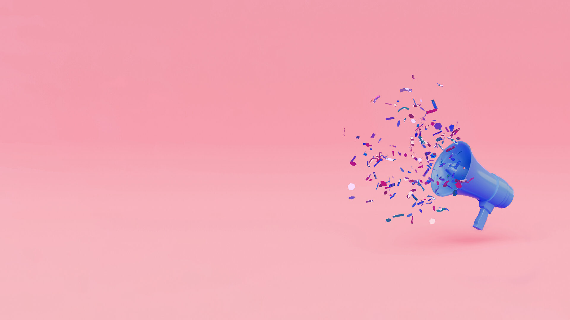 Ein mit Konfetti gefülltes blaues Megafon auf rosa Hintergrund.