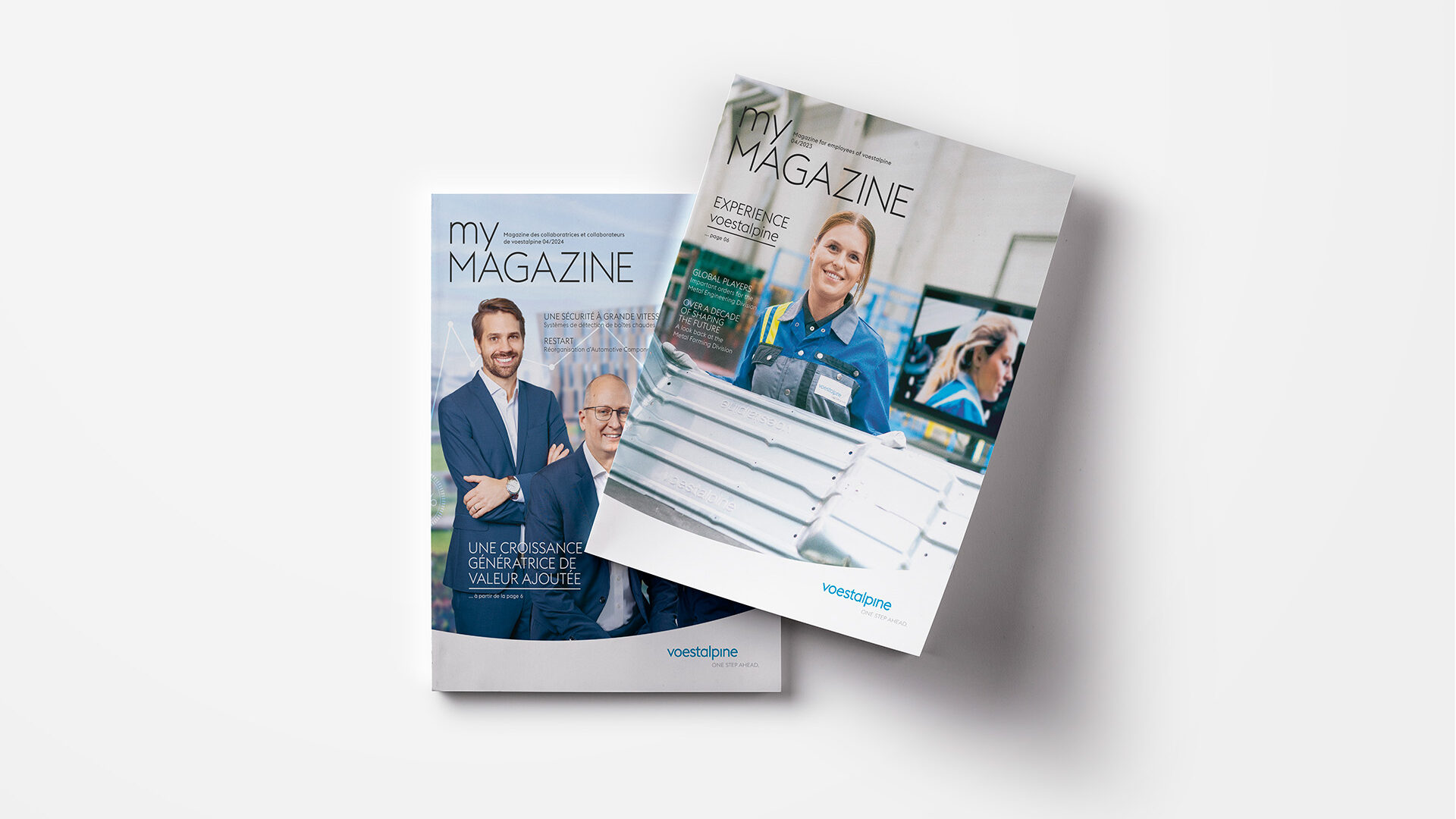 Zwei Zeitschriften liegen auf einer hellen Fläche. Die Titel zeigen professionell gekleidete Personen in Geschäfts- und Industrieumgebungen. Die Zeitschriften tragen die Titel „My Magazine“ und „Magazine“.